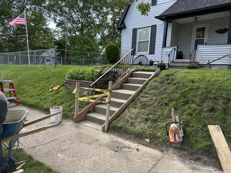New concrete front entry stairs formed and poured at a residential home during construction.